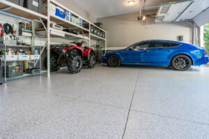 atv and blue sedan parked inside with pretty garage floors